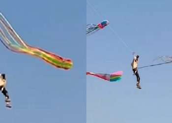 ঘুড়ির সুতো ধরে আকাশে উড়ছে যুবক